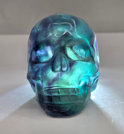 Backlit Fluorite skull carving on a white background