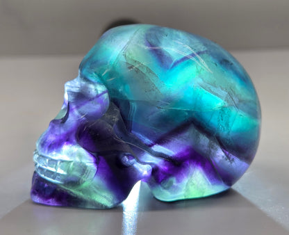 Backlit Fluorite skull carving on a white background