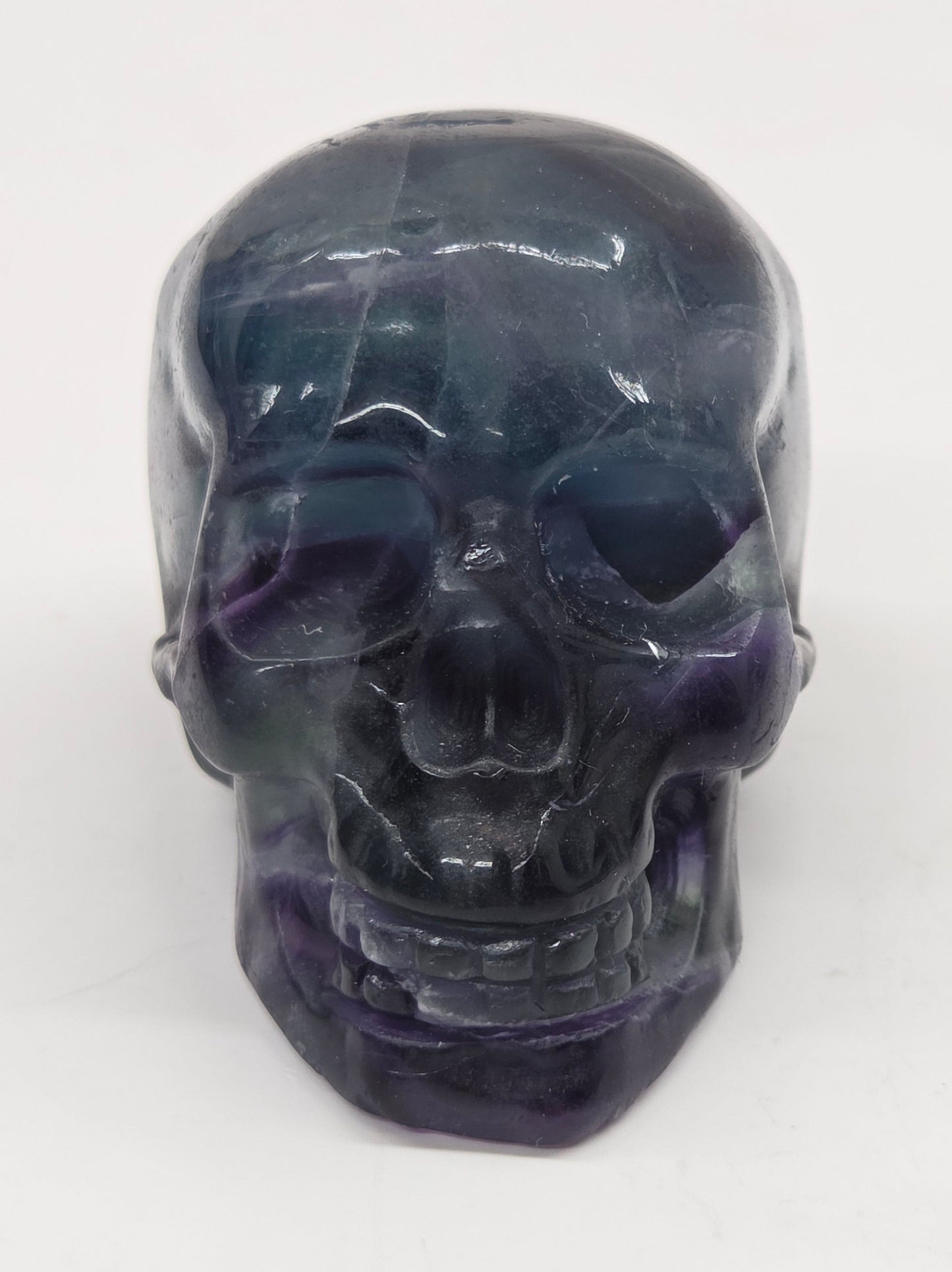 Fluorite skull carving on a white background