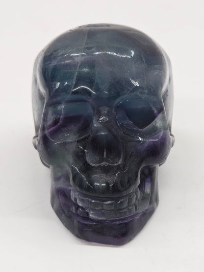 Fluorite skull carving on a white background