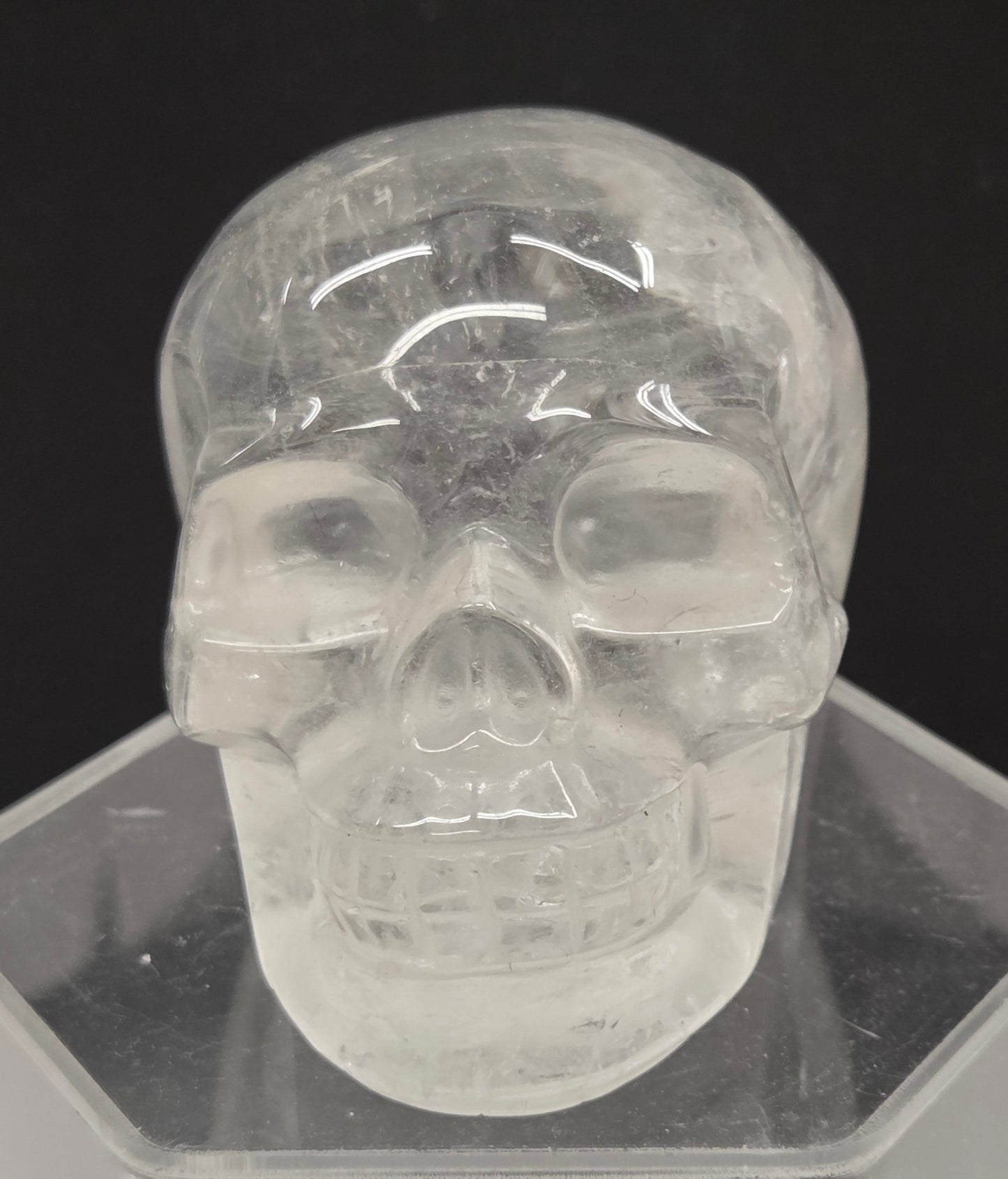 Clear Quartz skull on a black background