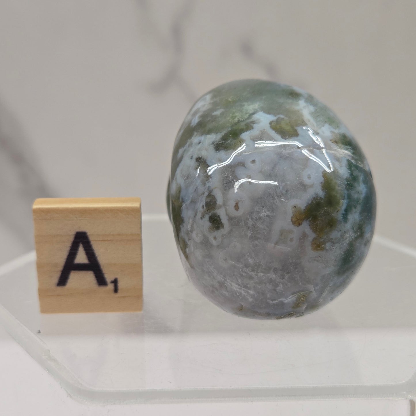 Moss Agate skull carving on a white background