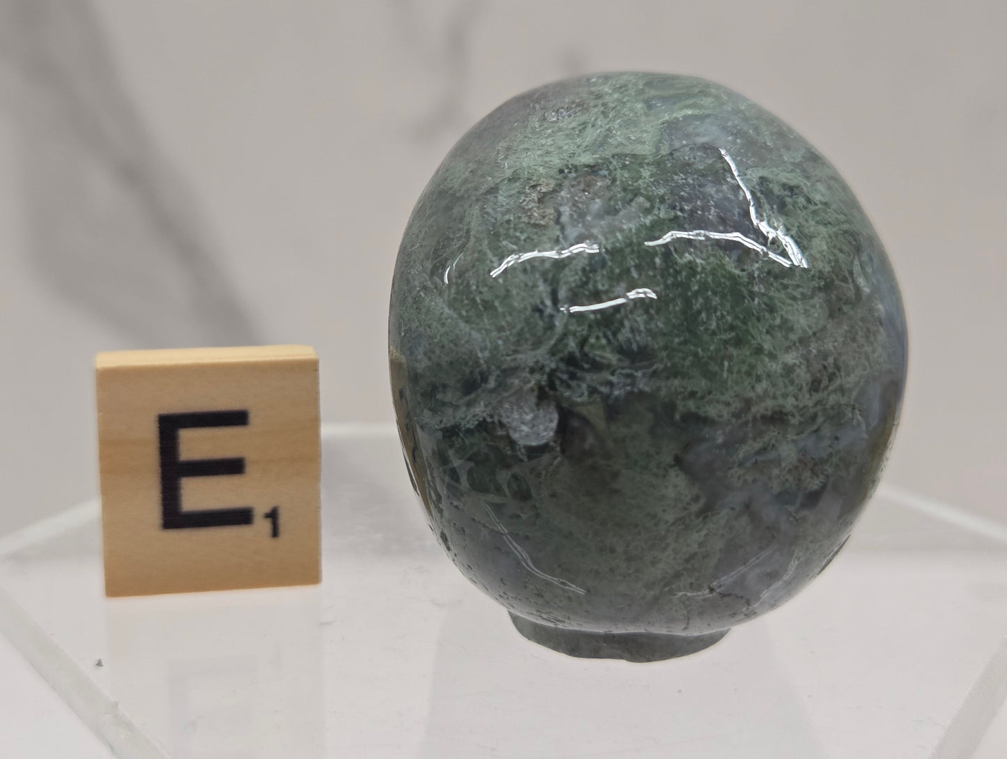 Moss Agate skull carving on a white background