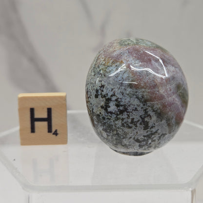 Moss Agate skull carving on a white background