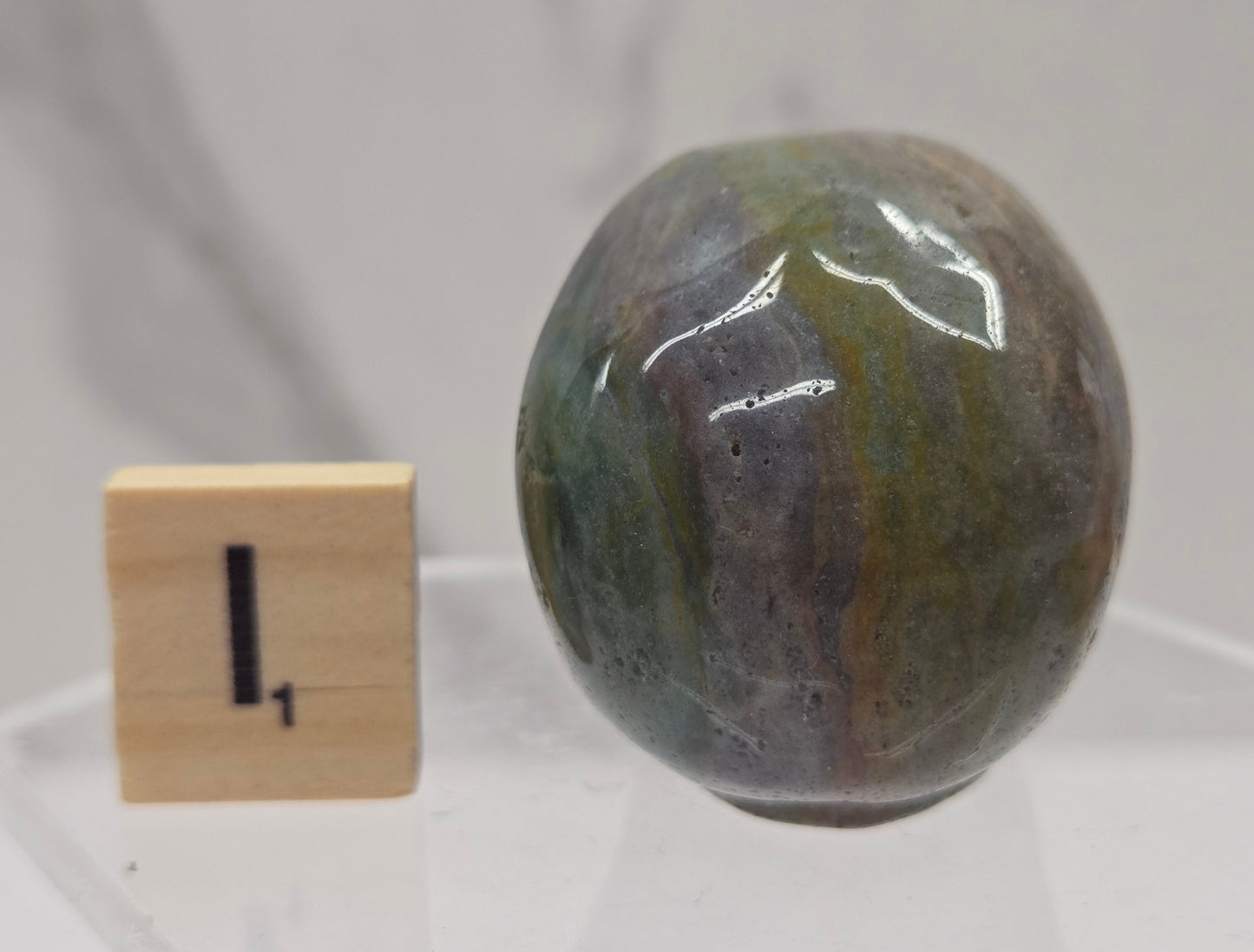 Moss Agate skull carving on a white background