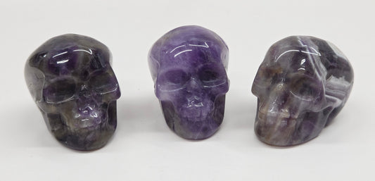 collection of amethyst skulls on a white background