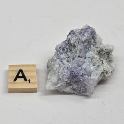 Mineral geode with white and purple coloring against a white background