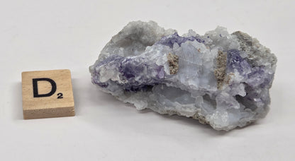 Mineral geode with white and purple coloring against a white background
