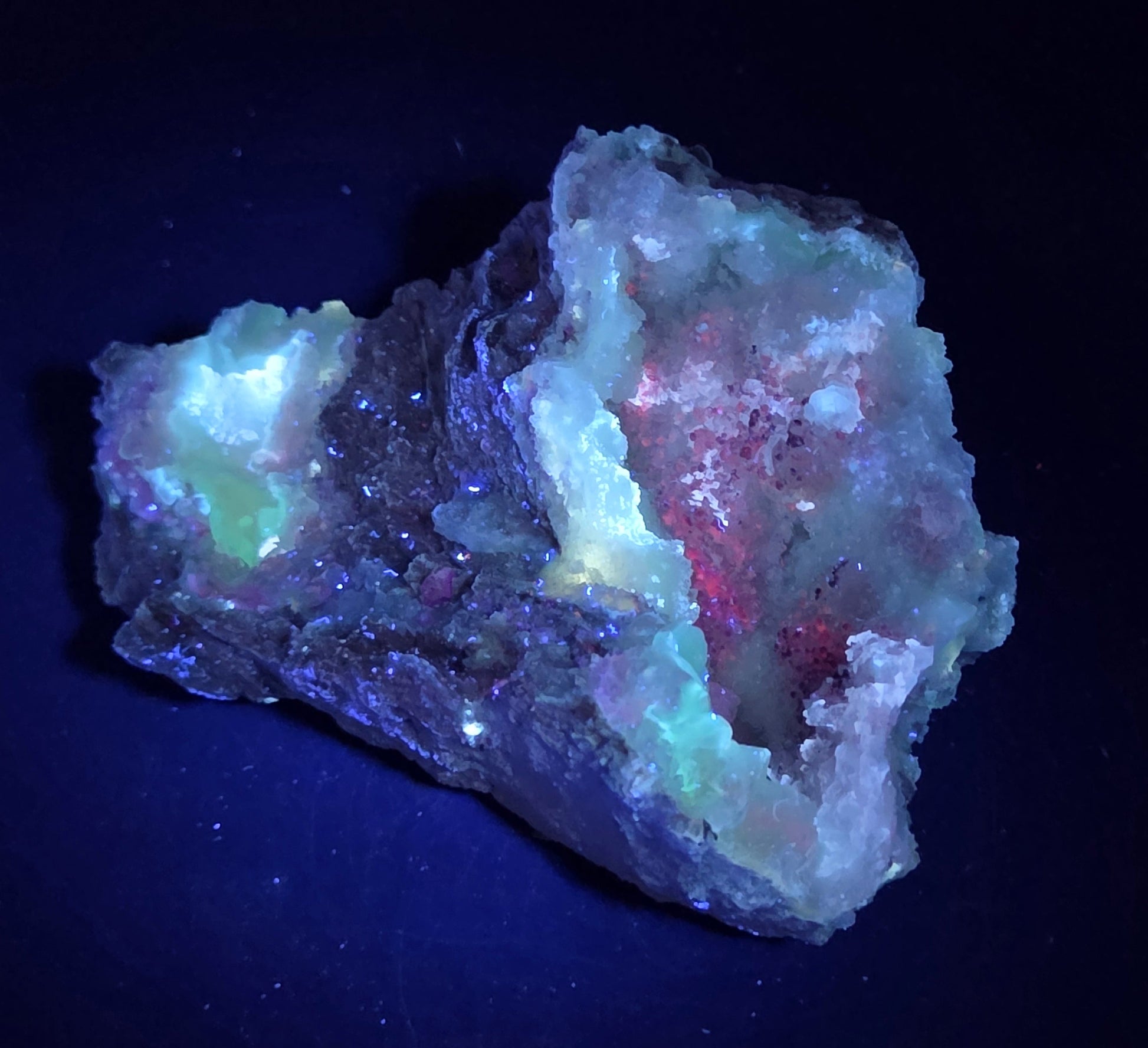 Mineral geode under UV light against a black background