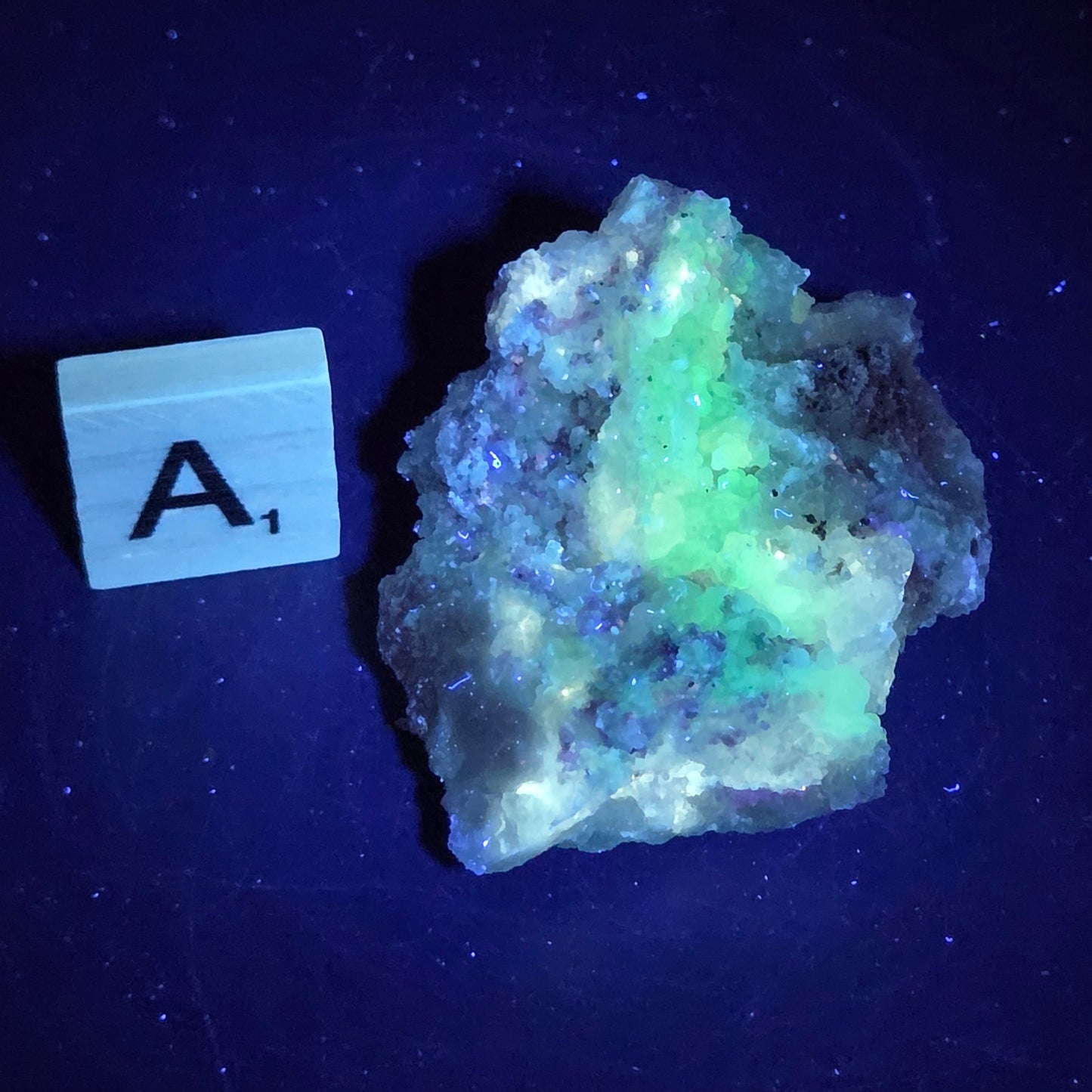 Mineral geode under UV light against a black background