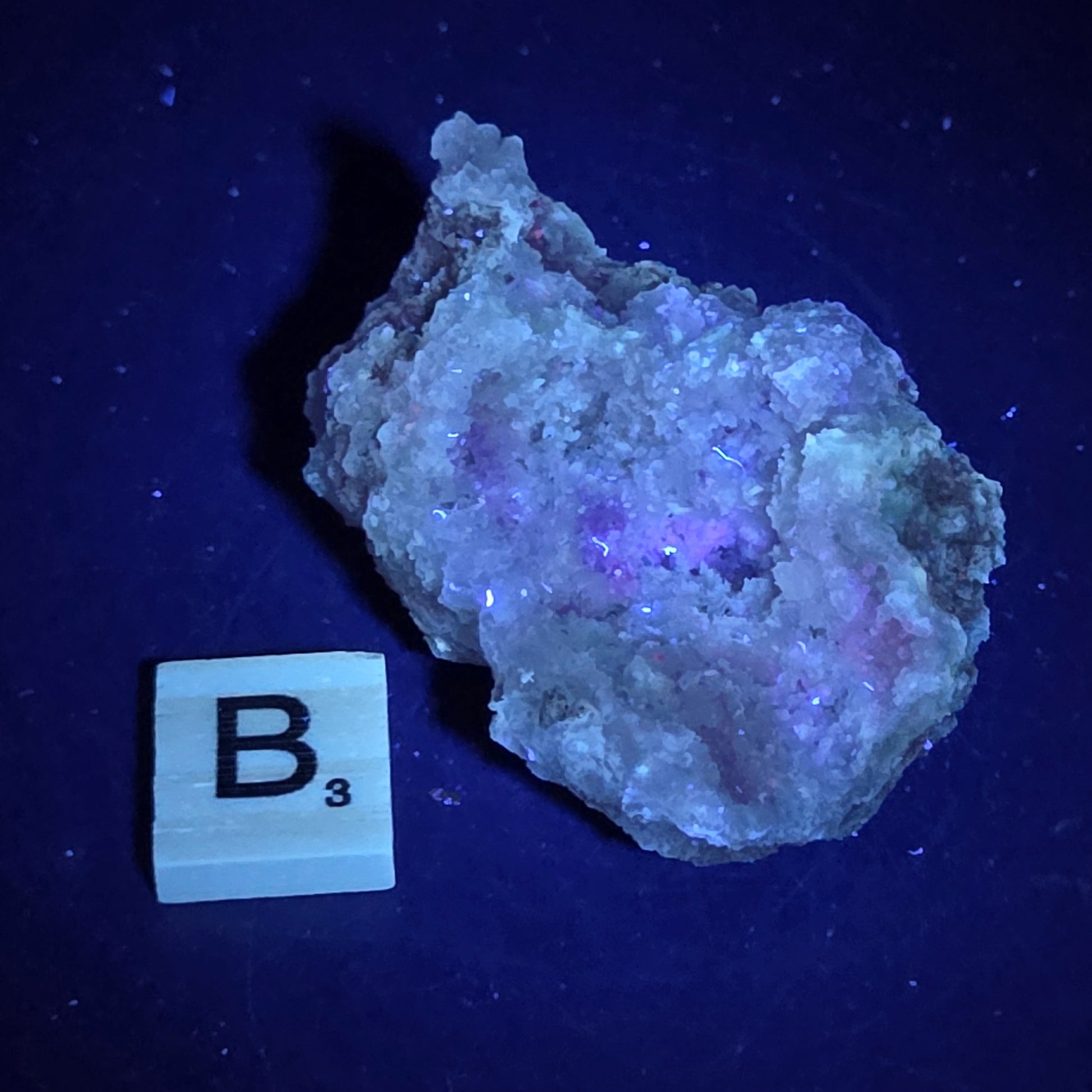 Mineral geode under UV light against a black background