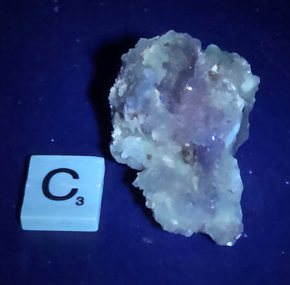 Mineral geode under UV light against a black background