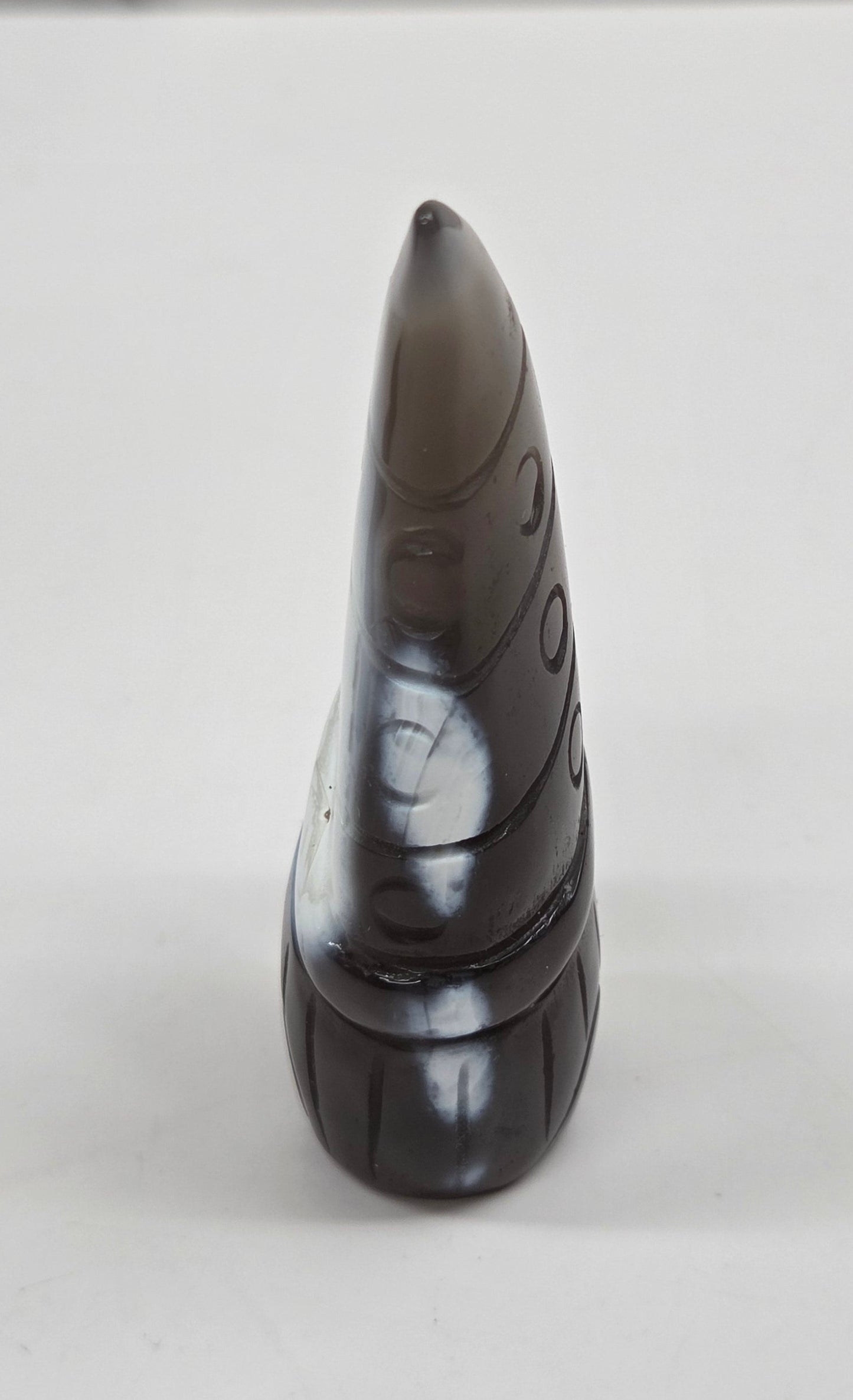 Black and white agate gnome shaped carving on a white background