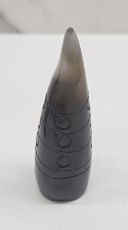 Black and white agate gnome shaped carving on a white background
