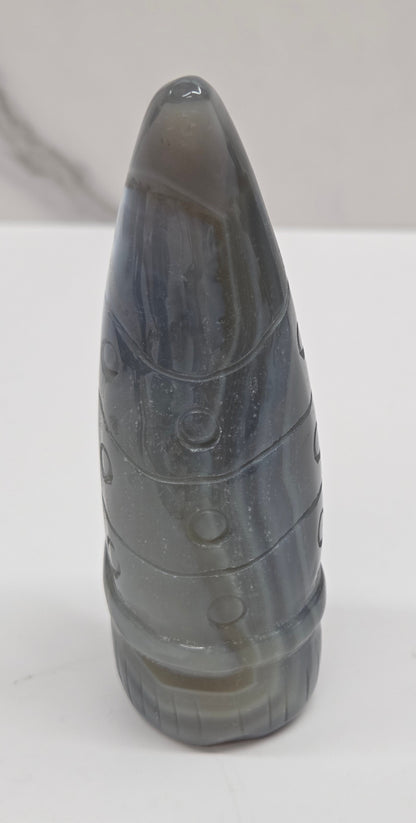 Black and white agate gnome shaped carving on a white background