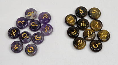 Two groups of round cabochon gemstone charms with gold zodiac symbols, displayed on a light gray background. The left group consists of purple amethyst stones, and the right group consists of brown tiger's eye stones.