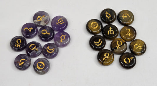 Two groups of round cabochon gemstone charms with gold zodiac symbols, displayed on a light gray background. The left group consists of purple amethyst stones, and the right group consists of brown tiger's eye stones.