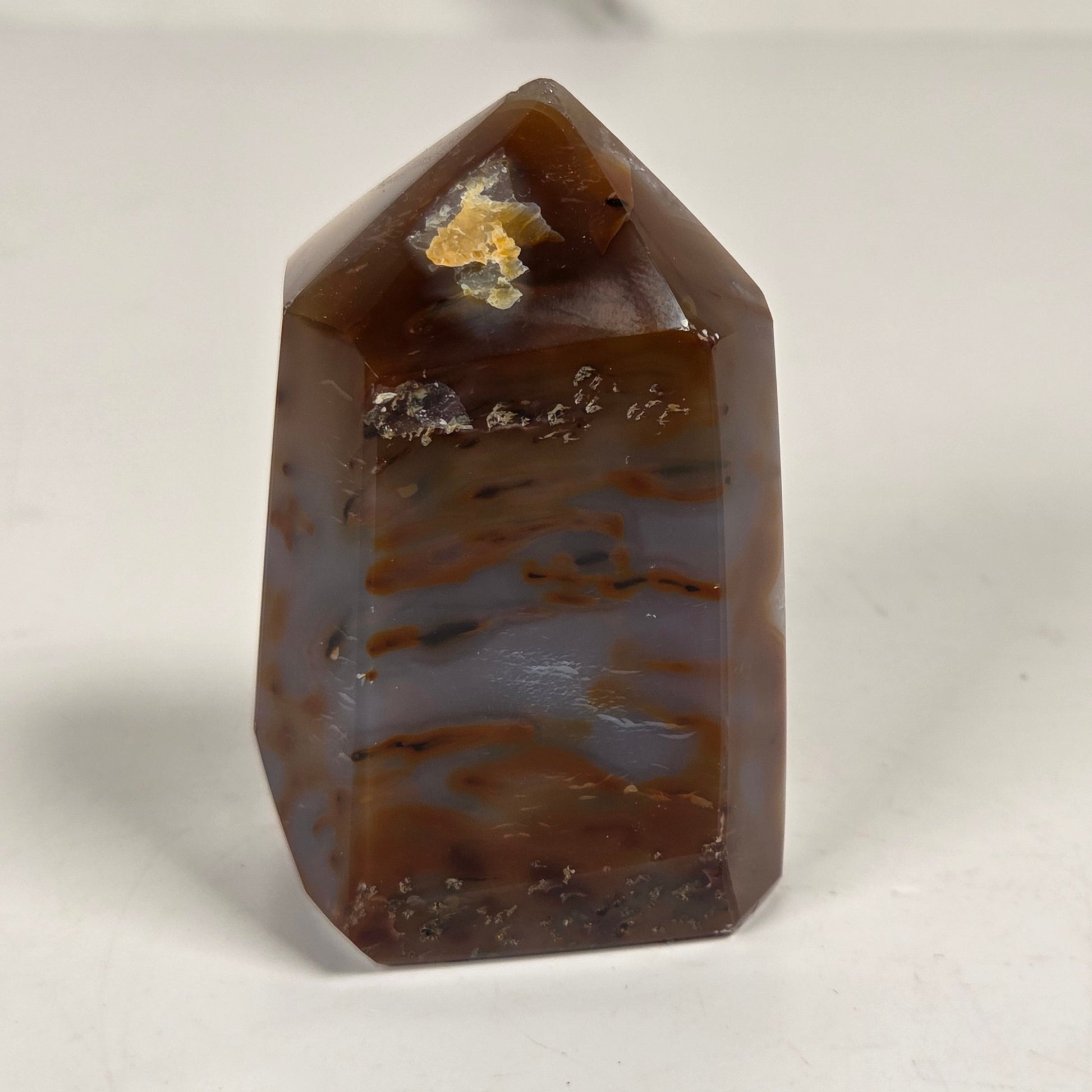 Agate with amethyst tower colorful bands of chalcedony agate on a white background