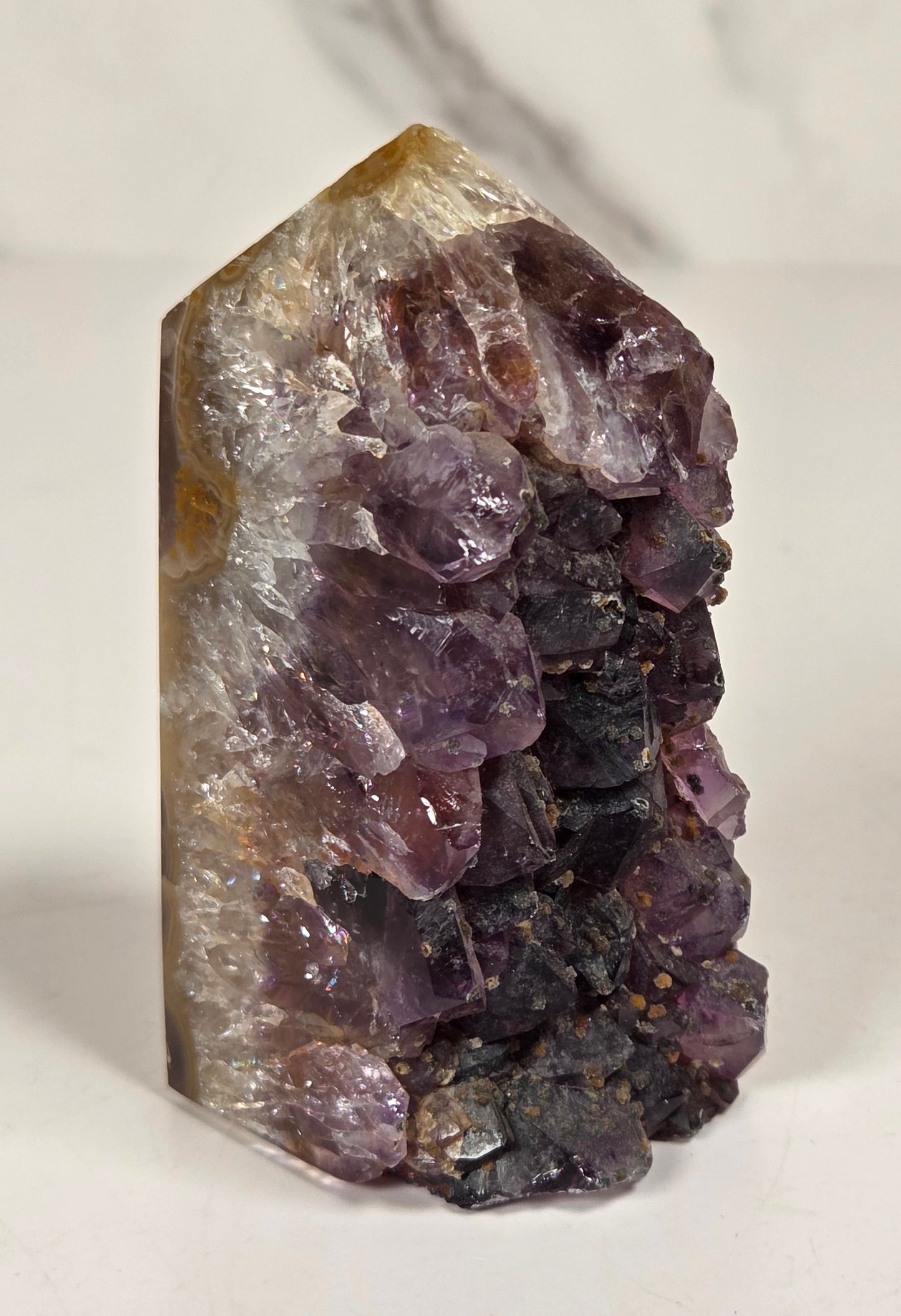 Agate with amethyst tower colorful bands of chalcedony agate on a white background