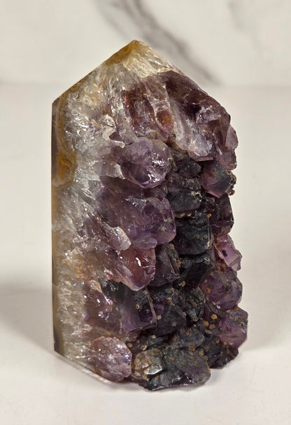 Agate with amethyst tower colorful bands of chalcedony agate on a white background