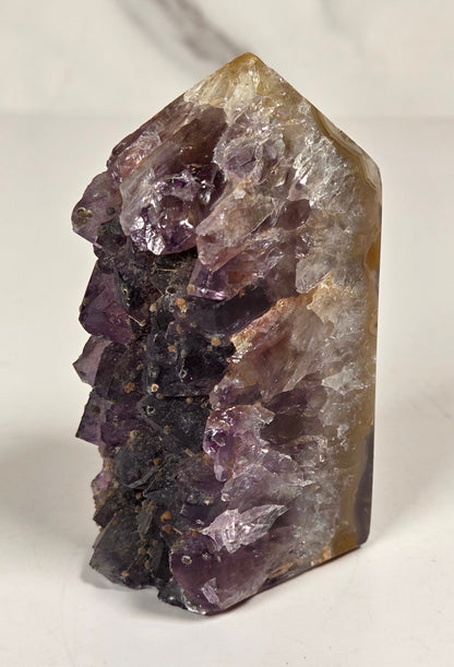 Agate with amethyst tower colorful bands of chalcedony agate on a white background