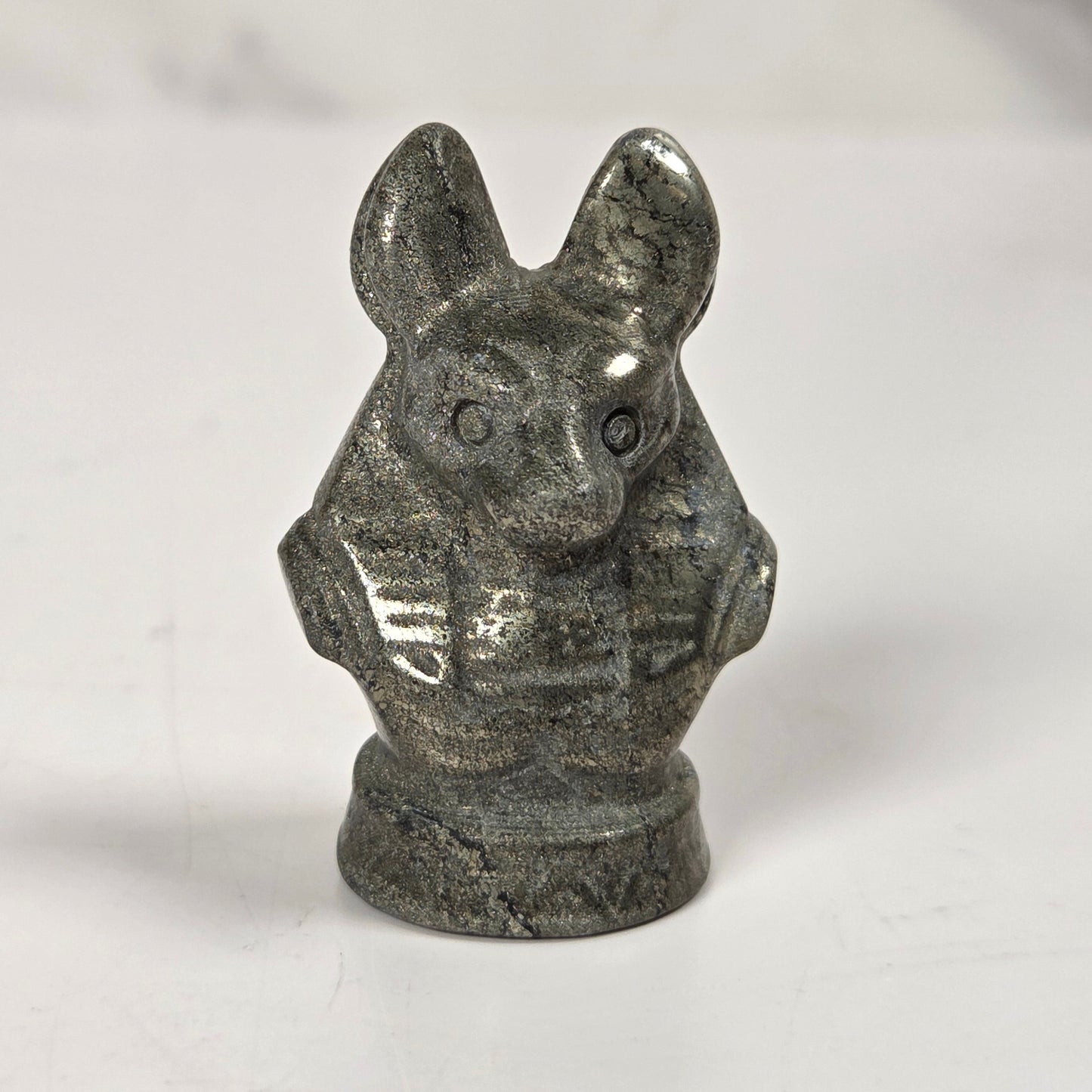 A small carved stone figurine of a rabbit or hare bust, shown on a plain light background.