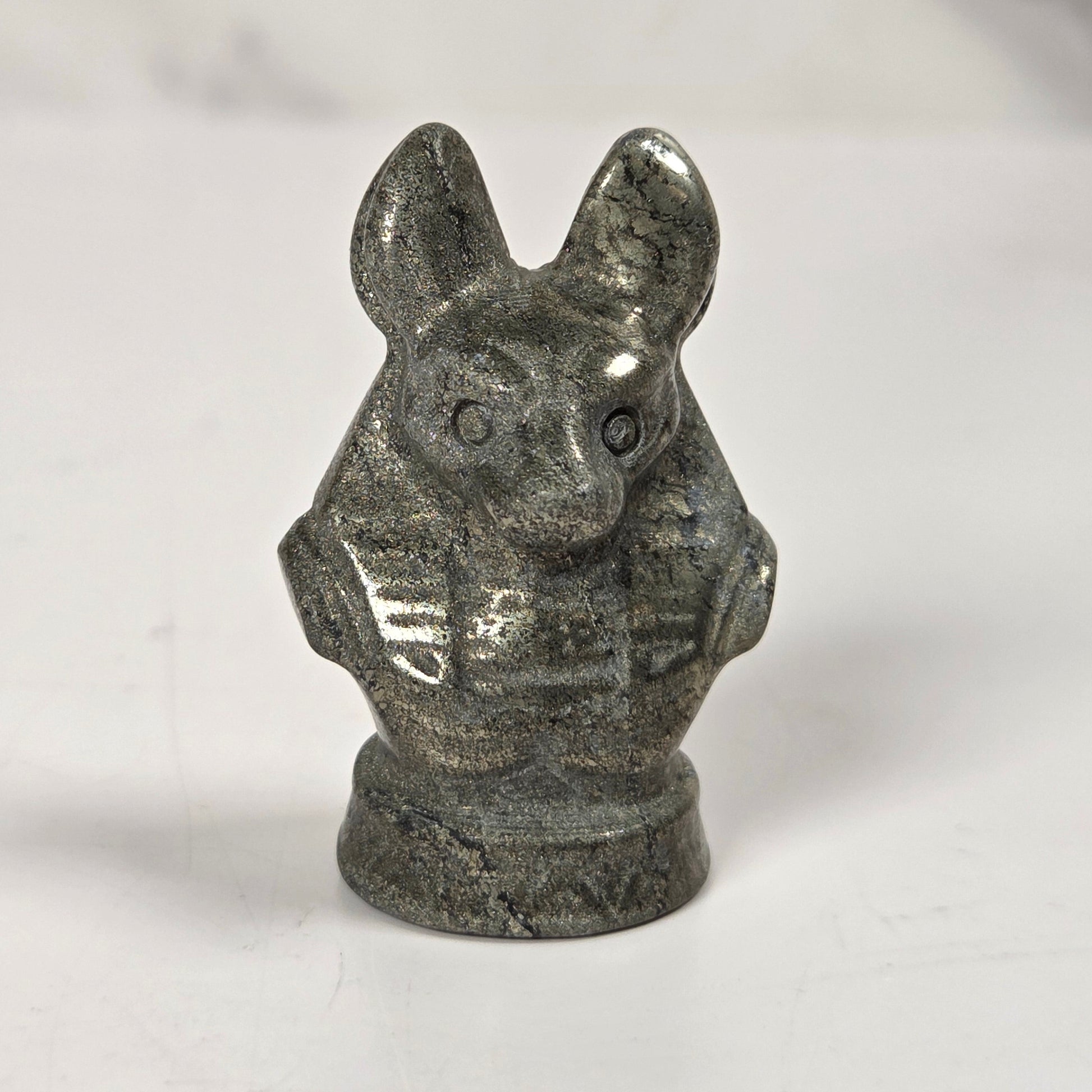 A small carved stone figurine of a rabbit or hare bust, shown on a plain light background.