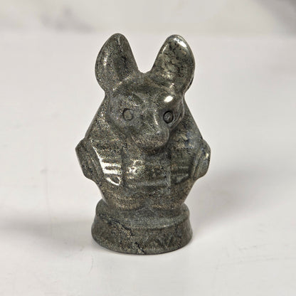 A small carved stone figurine of a rabbit or hare bust, shown on a plain light background.