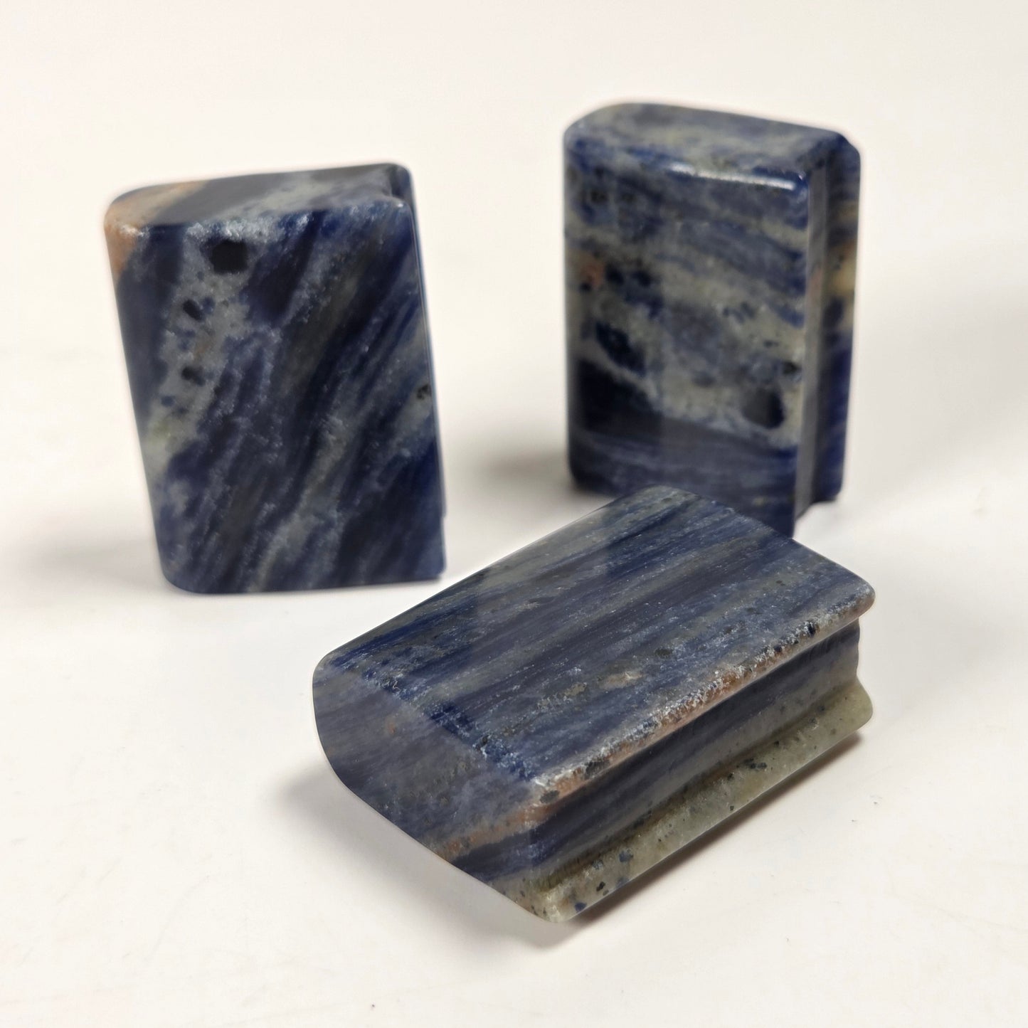 Three polished blue stone blocks with natural marbled patterns, displayed on a plain off-white background.