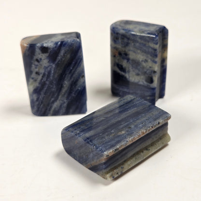 Three polished blue stone blocks with natural marbled patterns, displayed on a plain off-white background.
