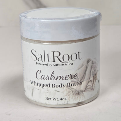 A 4 oz jar of SaltRoot Cashmere Whipped Body Butter, featuring a white label with black text and a seashell illustration, set against a neutral light gray background.