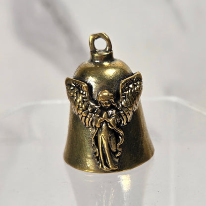 A small antique bronze angel bell charm with a detailed winged angel figure, displayed on a clear acrylic stand against a light gray marble-patterned background.