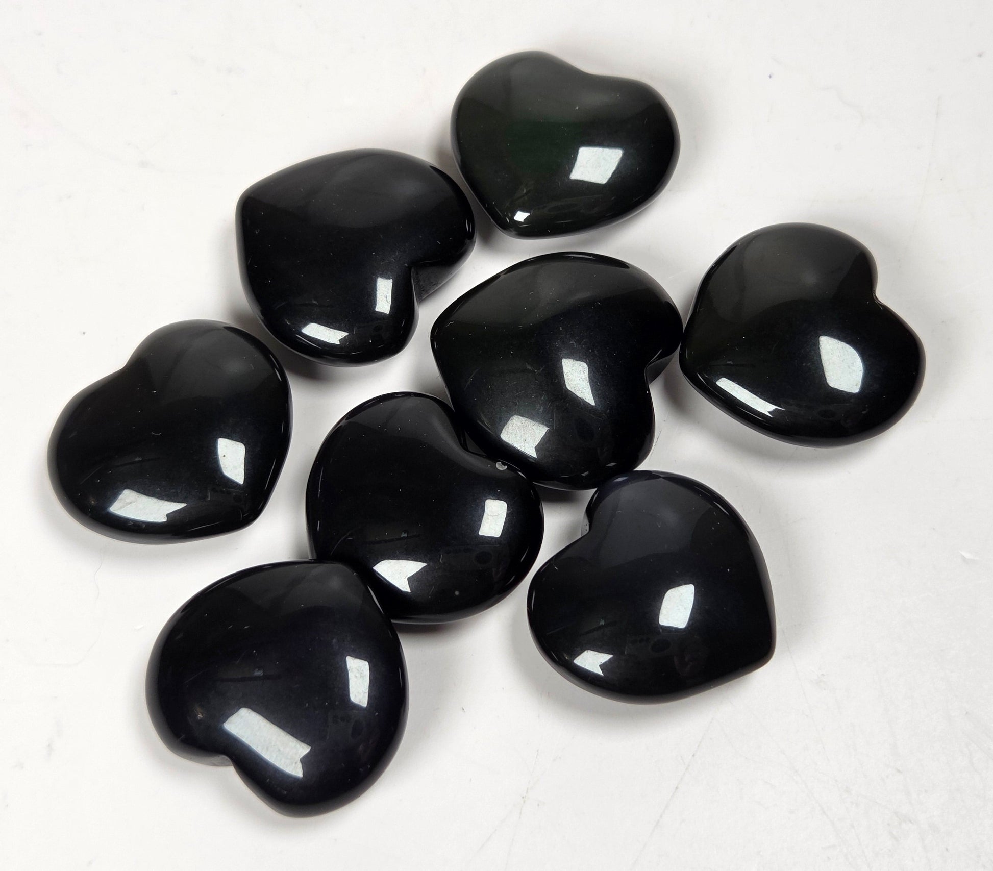 Black Obsidian heart carvings on a white background