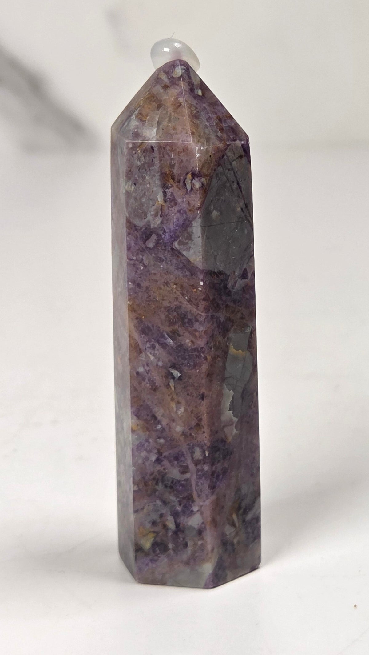 Brecciated Fluorite tower against a white background