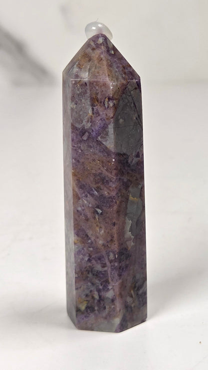 Brecciated Fluorite tower against a white background