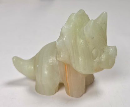 A small carved animal figurine, shaped like a horse or pony, made from pale translucent stone with a warm peach undertone, set against a plain light background.