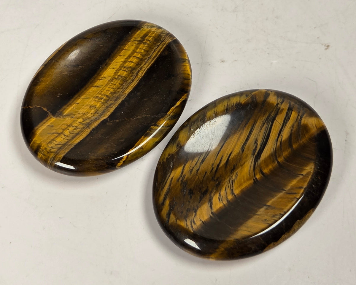 tigers eye crystal carvings against a white background