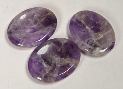 dream amethyst crystal carvings against a white background