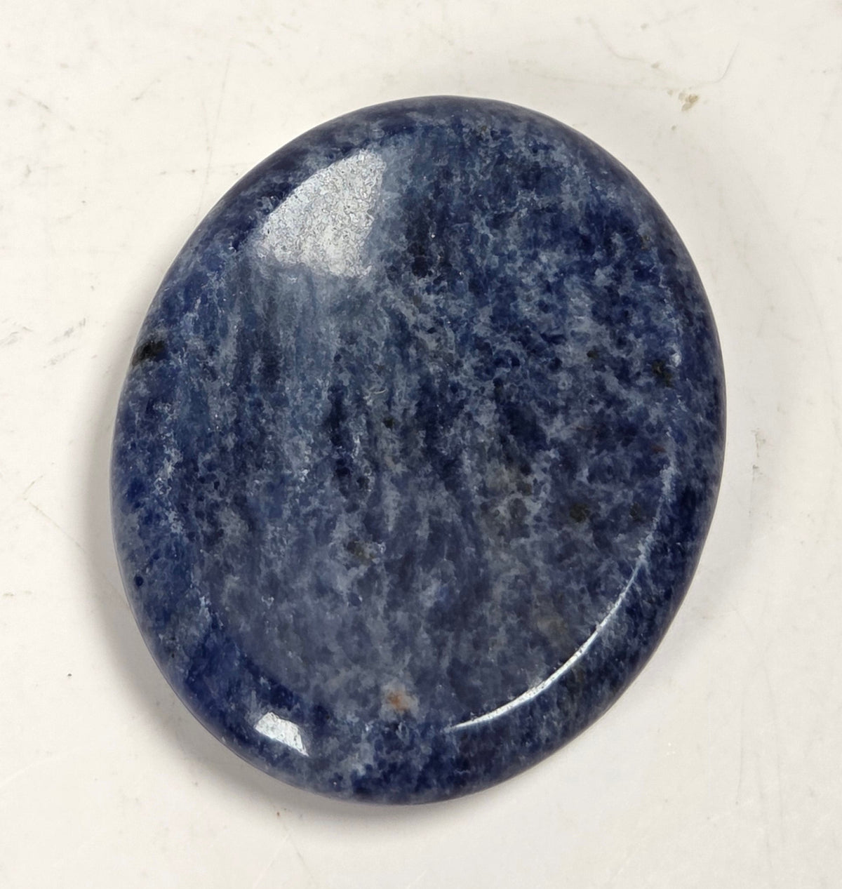 sodalite crystal carving against a white background