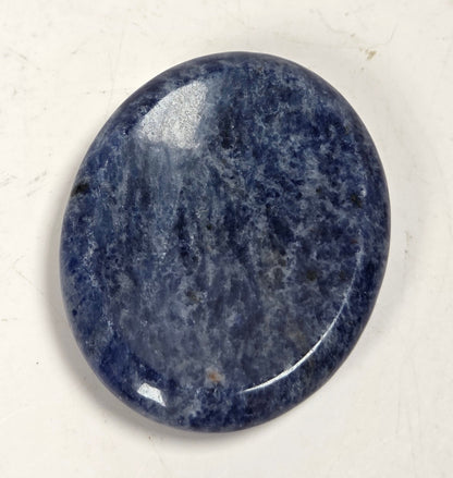 sodalite crystal carving against a white background