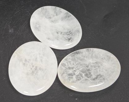 clear quartz crystal carvings against a white background