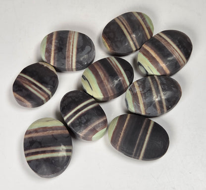 Striped crystal carvings in an oval shape against a white background