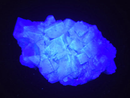 Fluorite specimen under UV light showing a blue color