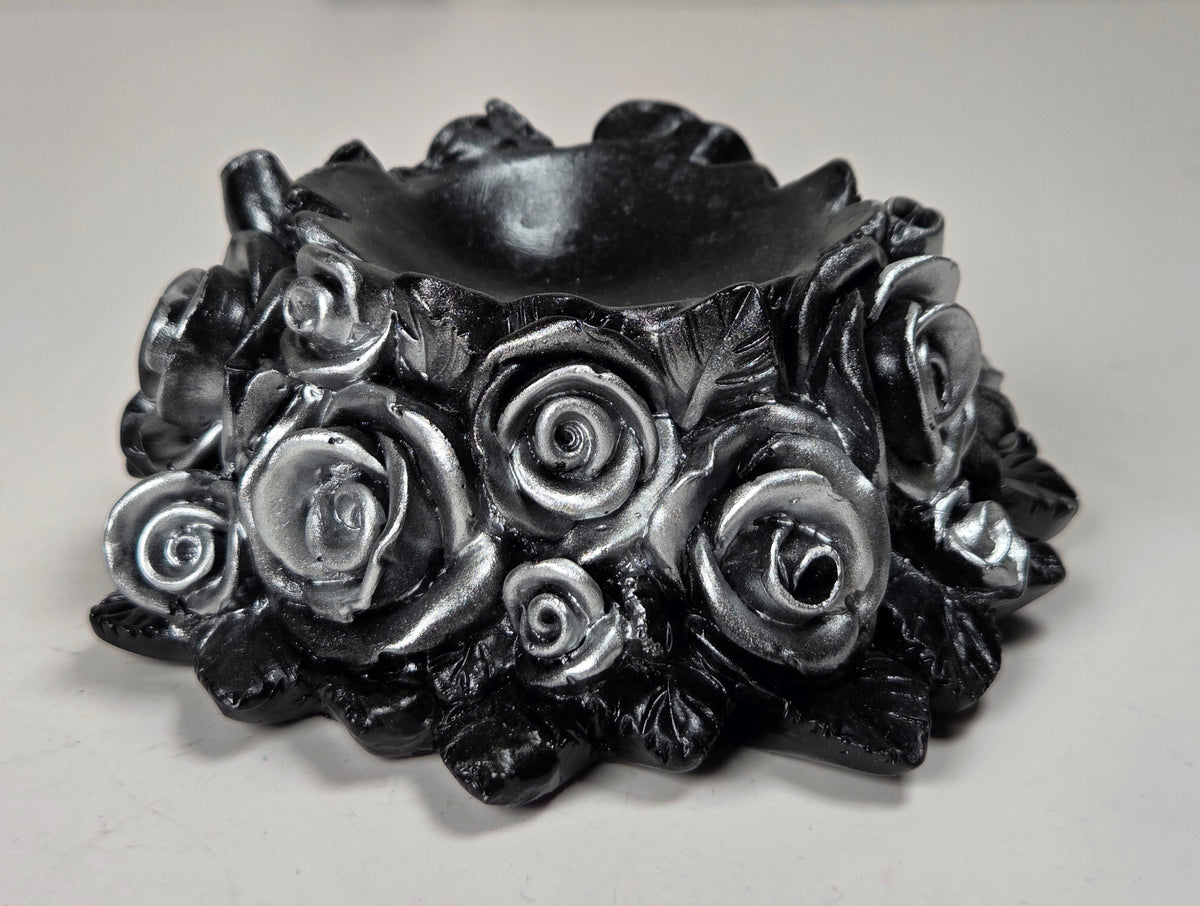 plastic sphere holder with silver roses against a marble background