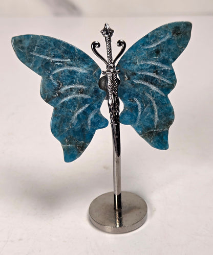 blue crystal wing carvings on a silver metal stand against a white background
