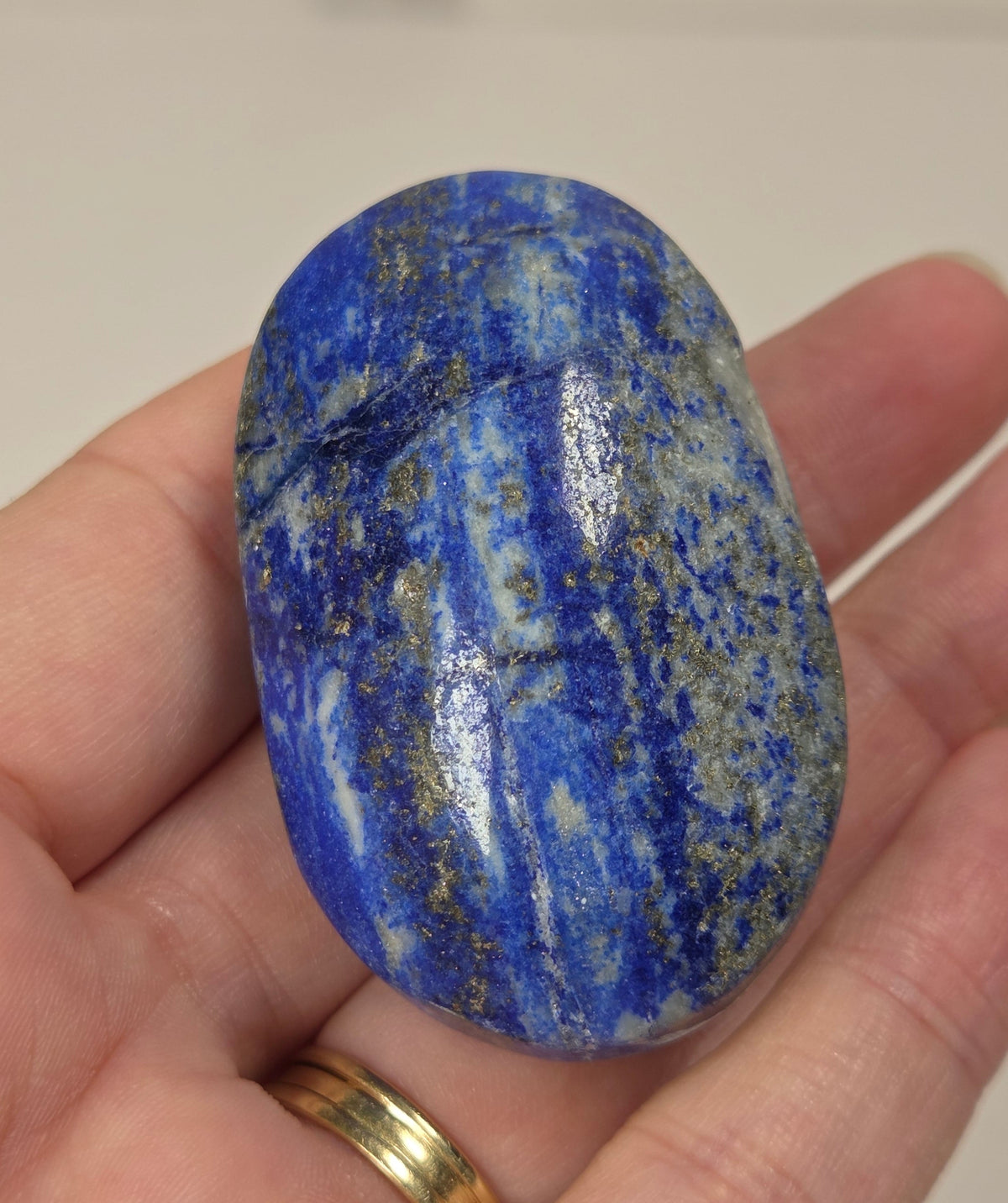 Lapis Lazuli polished palm with white, grey and blue coloring