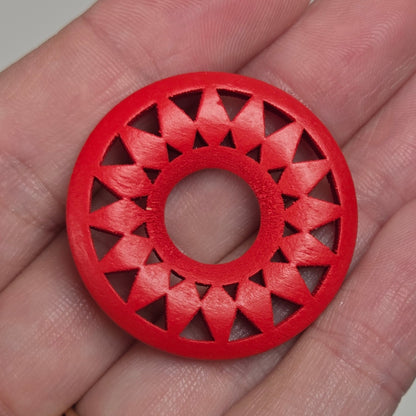 hand holding a starburst style wood circle on a white background