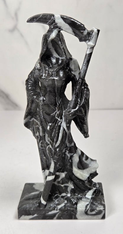 faceless lady reaper carving made of a  marbled black and white mineral against a marbled white background