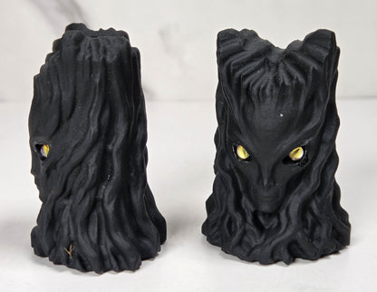 faceless lady reaper carving made of a  off-white mineral against a marbled white background