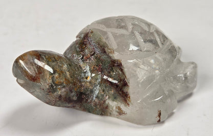 Turtle shaped garden quartz crystal carving on a white background